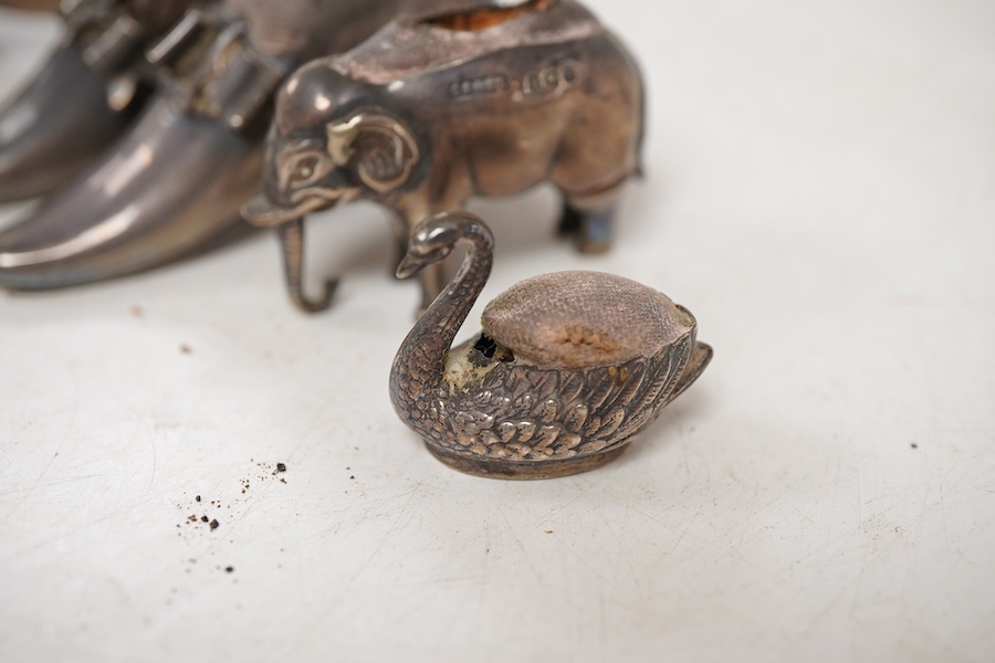 Five assorted novelty silver pin cushions, to include a model pig, maker's mark rubbed, Birmingham, 1903, length 67mm, two model shoes by Adie & Lovekin, a small elephant by Saunders & Shepherd, Birmingham, 1905 and a ti